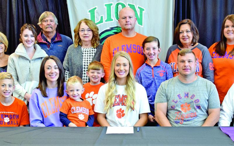 Pictured at Jaden Cheek’s scholarship signing with Clemson University last week are (front, from left) Carson Cheek, Megan Cheek, Cullen Cheek, Jaden Cheek, Jeff Cheek, Joe Cheek, (back) Joey Cheek, Sherri Cheek, Alex McLeroy, Mike Carson, Ellene Carson, Tucker Ruark, Matt Ruark, McKinlee Turner, Terri Cheek and April Ruark. Jaden is also the granddaughter of the late Raynell Cheek.