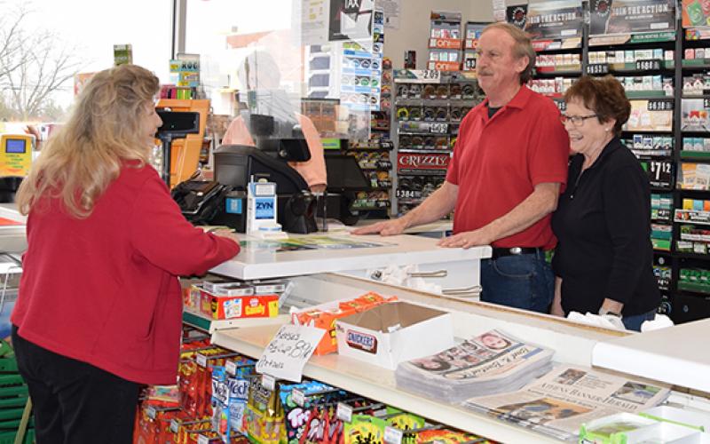 Carol Messer chats with Bobby and Sue Sexton last week, on what was originally their last day at Dixie Dale. The sale of the store was delayed a week. (Photo by Sinclair)