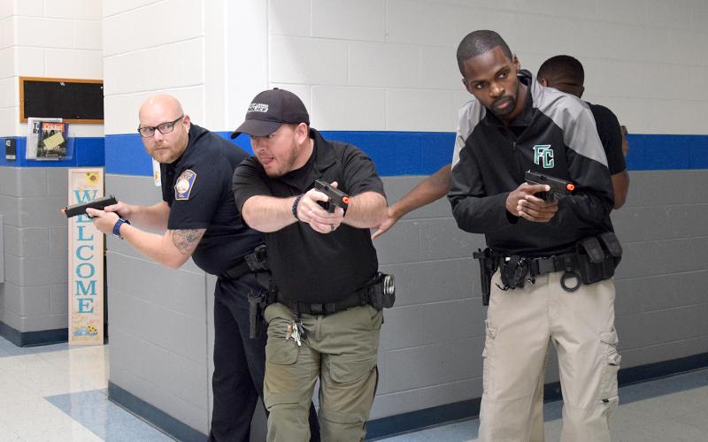 Assistant Lavonia Police Chief Daniel Carson and officers Justin Parten, Jay Thomas and Brian Neal practice a scanning technique for entering a T-shaped hallway during active shooter training Tuesday at Lavonia Elementary School. (Photo by Sinclair)