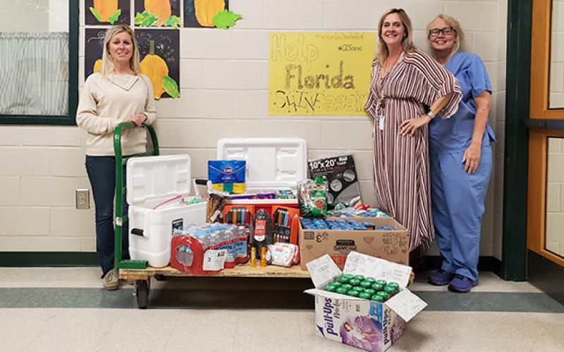 Carnesville Elementary School Assistant Principal Delina Wester, Principal Karen Correia and Nurse Norina South are proud of the community for already giving to families in Florida affected by Hurricane Ian. The donations will be driven to Myakka City, Fla., where much of South’s family lives. Donations will be taken at several locations in Franklin County through Friday before they are transported to Florida. (Photo by Sinclair)