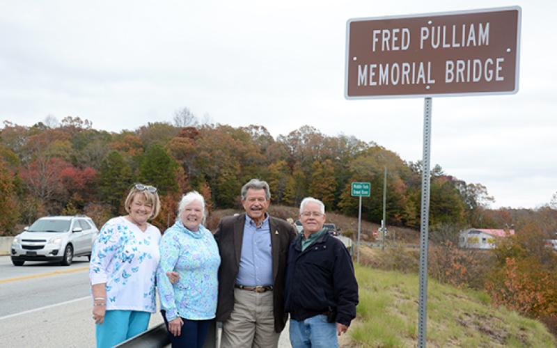 The children of Fred Pulliam – Bobbie Starcher, Robbie Ayers and Freddy Pulliam – pose with State Rep. Alan Powell, who ushered a resolution through the Georgia General Assembly to name the bridge after their father.  (Photo by Scoggins)