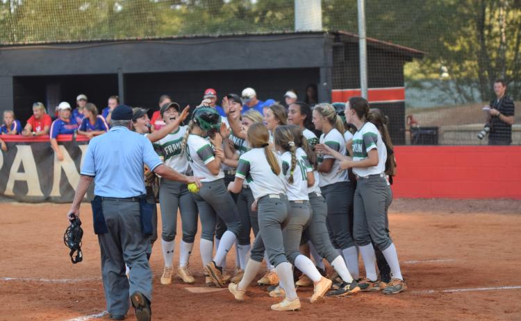 The Franklin County Lady Lions, pictured celebrating a Jaden Cheek home run during the region championship game, will host Coahulla Creek Wednesday for a doubleheader in the first round of the state tournament.