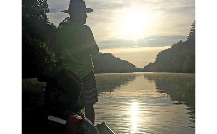 Jacob Duckett takes a turn leading the way down the Broad River on the last morning of a three-day journey down river by jon boat with friends Trevor and Miles McBath.