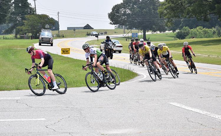 Bicycle racers make the turn into the Franklin County High School campus Sunday. (Photo by Scoggins)