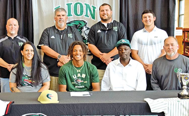C.J. Blackwell signed a college baseball scholarship recently. A celebration was held for him at Franklin County High School. Pictured are (front, from left) his mother Laura Smith, C.J., his father Corey Blackwell, Franklin County Athletic Director Jason Oliver, (back) Franklin County High School Principal Roger Wilkinson, FCHS Baseball Coach David Skelly and assistant coaches Ryan Phillips and Elliott Beard. (Photo by Scoggins)