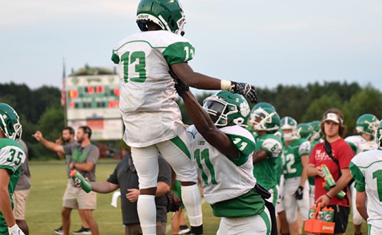 A.J. Elliott (No. 13) and Josh Butler (No. 11) celebrate a touchdown Friday in a Green-White Scrimmage held at Ed Bryant Stadium. (Photo by Scoggins)