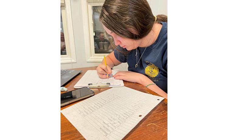 Hallie Ferguson works to translate a list of medical supplies for Love Him Love Them. Ferguson inspired the Franklin County Middle School FFA to support the local ministry.
