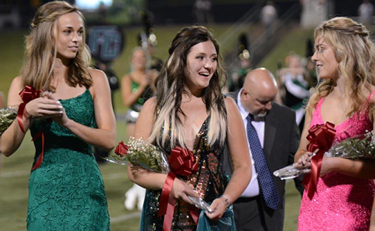 Newly announced 2021 Franklin County High School Homecoming Queen Alexia Vaughn (center) smiles at Sarah York (right) as Bailey Aderholdt (left) looks on during halftime ceremonies Friday at Ed Bryant Stadium. (Photo by Scoggins)