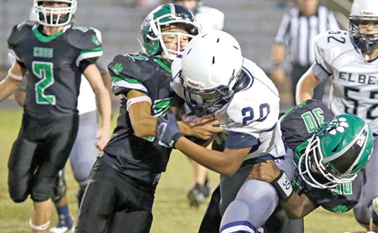 Carson Cheek (left) and Carmelo Hines (right) wrestle an Elbert County ballcarrier to the ground last week during the NEGIAA region football playoff semifinals at Ed Bryant Stadium. (Photo by Rose Scoggins of The Elberton Star)