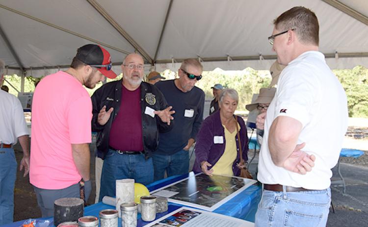 Rodney Swinson (center), who lives in the Bradford Place subdivision adjacent to where Vulcan Materials plans to build a rock quarry, shares concerns during a neighborhood information session set up by the company Tuesday. (Photo by Sinclair)