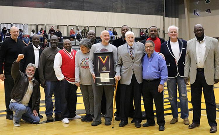 Former Emmanuel College Athletic Director and Head Men’s Basketball Coach Jim Ganey (second from right on front row) was inducted into the college’s Hall of Fame Saturday. He was joined by a host of former players for the event.