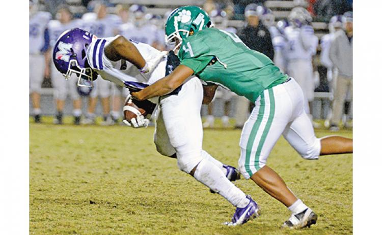 Charles Ware (No. 4) brings down a Monroe ball carrier. (Photo by Scoggins)