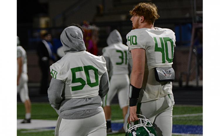 Senior Keylan Rutledge (No. 40) walks off the field for the final time in high school with injured junior center Tarryn Tate following Franklin’s loss to Oconee, now ranked No. 2 in the state. (Photo by Scoggins)
