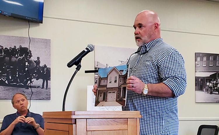 Scott Appling of GDP Investments shows an image of a unit recently built in Newnan, which is similar to what he plans to build in Lavonia. (Photo by Sinclair)