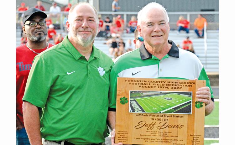 Franklin County Athletic Director Jason Oliver presents Jeff Davis with a plaque Friday commemorating the naming of the football field at Ed Bryant Stadium in Davis’ honor. (Photo by Scoggins)