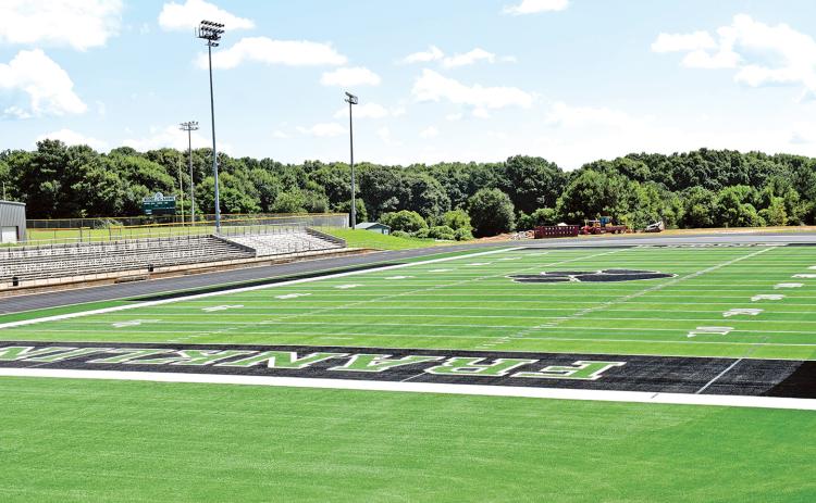Renovations to Ed Bryant Stadium began the day after graduation in May, with the removal of the grass playing surface. Workers then graded several inches of dirt from the field and spread loads of gravel before the playing surface was installed in pieces.