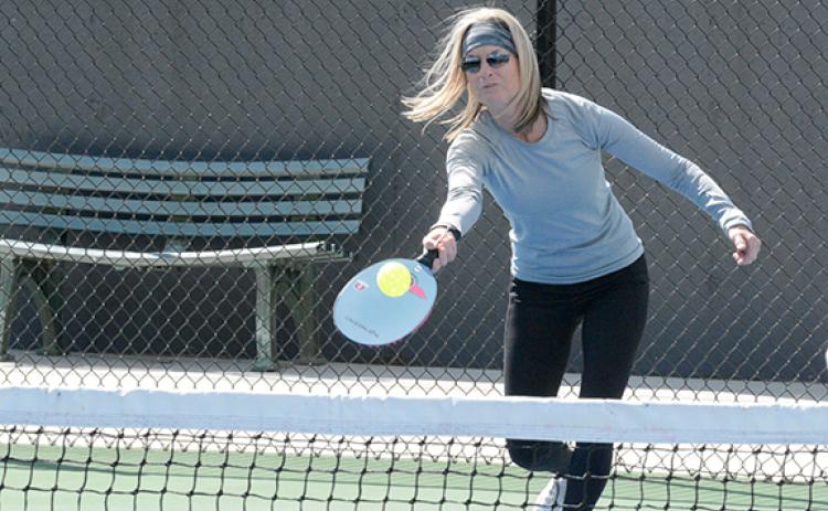 Tammy Pitt reaches for a return in her mixed doubles match at the Bell Family YMCA on Friday, April 8, 2022. Pickleball facilities are a possibility for Lavonia if the SPLOST is continued. (Photo by The Hartwell Sun)