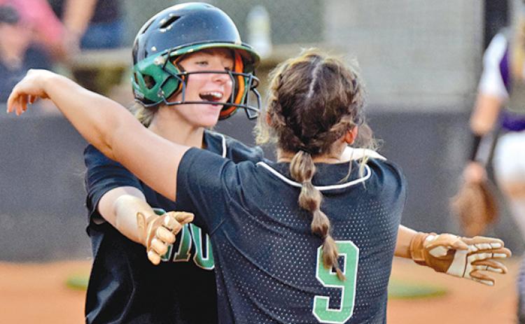 Savanna Lewis rushes to hug Madison Bryson (No. 9) after Bryson’s double drove in Lewis and Journey Roberts to win Tuesday’s softball game with Monroe Area. (Photo by Scoggins)