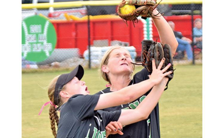 Lady Lion Journey Roberts makes a catch for an out over teammate (and sister) Lenox Roberts during the Region 8AAA tournament against Oconee County Oct. 12. (Photo by Scoggins)
