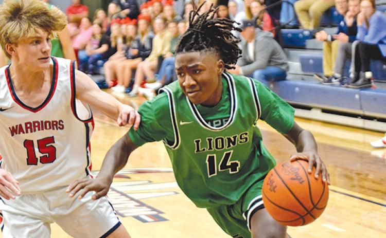 Mylan Roebuck drives past a West-Oak defender on the way to the basket in action Monday in Westminster. (Photo by Scoggins)