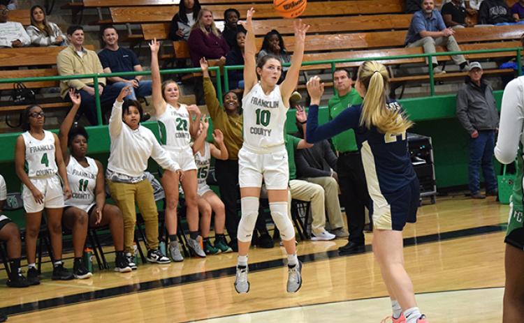 Calin Baird puts up a three-point shot against Seneca, S.C., as her teammates  show they expect it to go in. Baird, Journey Roberts, Lay Lay Sturghill and Paris Gaye will be honored Tuesday during Senior Night. (Photo by Scoggins)
