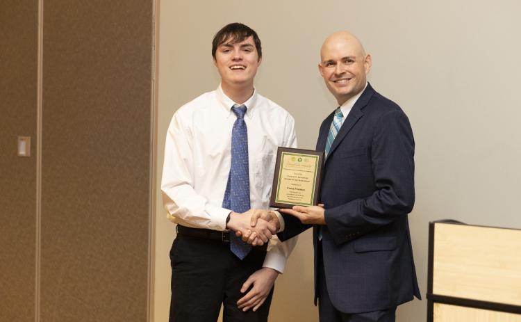 Franklin County Chamber of Commerce President Raymond Fitzpatrick (right) presents Christopher Forrer with a plaque honoring late Franklin County School Superintendent Chris Forrer as the chamber’s Charles Bradshaw Citizen of the Year. The award was presented at the chamber’s Membership Gala Thursday at the North Georgia Tech Currahee Campus.