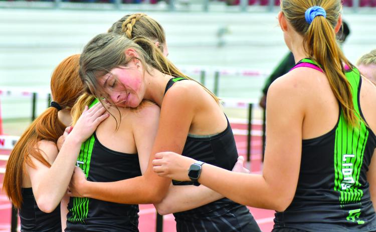The Franklin County Lady Lions’ 4x800 relay team of Jocelyn Dean, Ella Hodges, Katie Mathis and Megan Hightower celebrate their first-place finish at the Bo James Invitational Saturday in Rabun County. (Photos courtesy of The Clayton Tribune)
