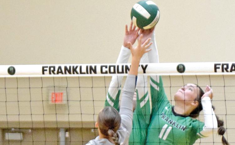 The Franklin County Lady Lion volleyball team has picked up two victories early in its 2023 season. Avery Burton (No. 11) blocks an East Jackson shot during the contest. (Photos by Scoggins)