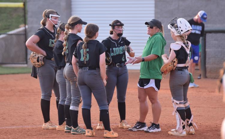 Head Coach Cherokee Bell (right photo) meets with her infield during Tuesday’s contest. (Photos by Scoggins)