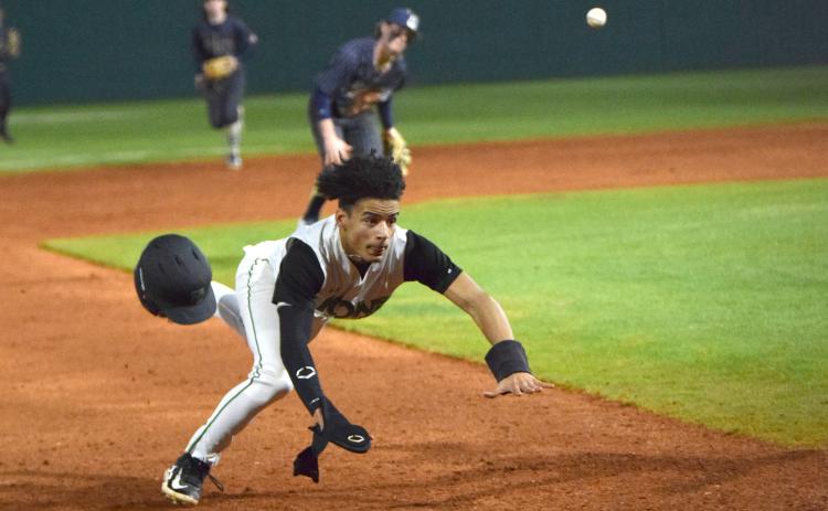 Kain Roach dives into third base after serving as a courtesy runner against Apalachee. (Photo by Scoggins)