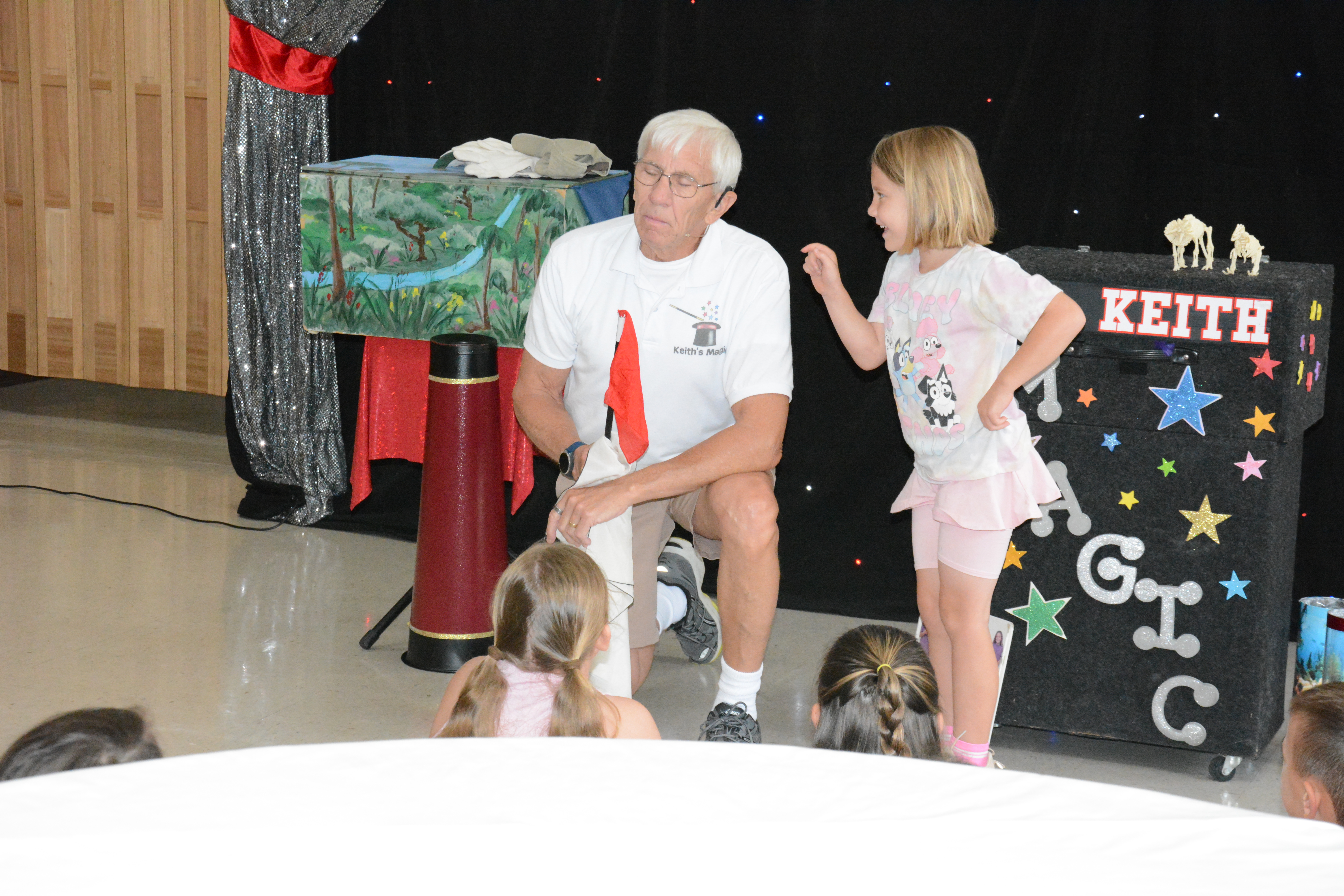 Katherine Gray (top photo) helps out magician and ventriloquist Keith Karnok as he performs for the Lavonia Carnegie Library’s summer reading program on Tuesday.