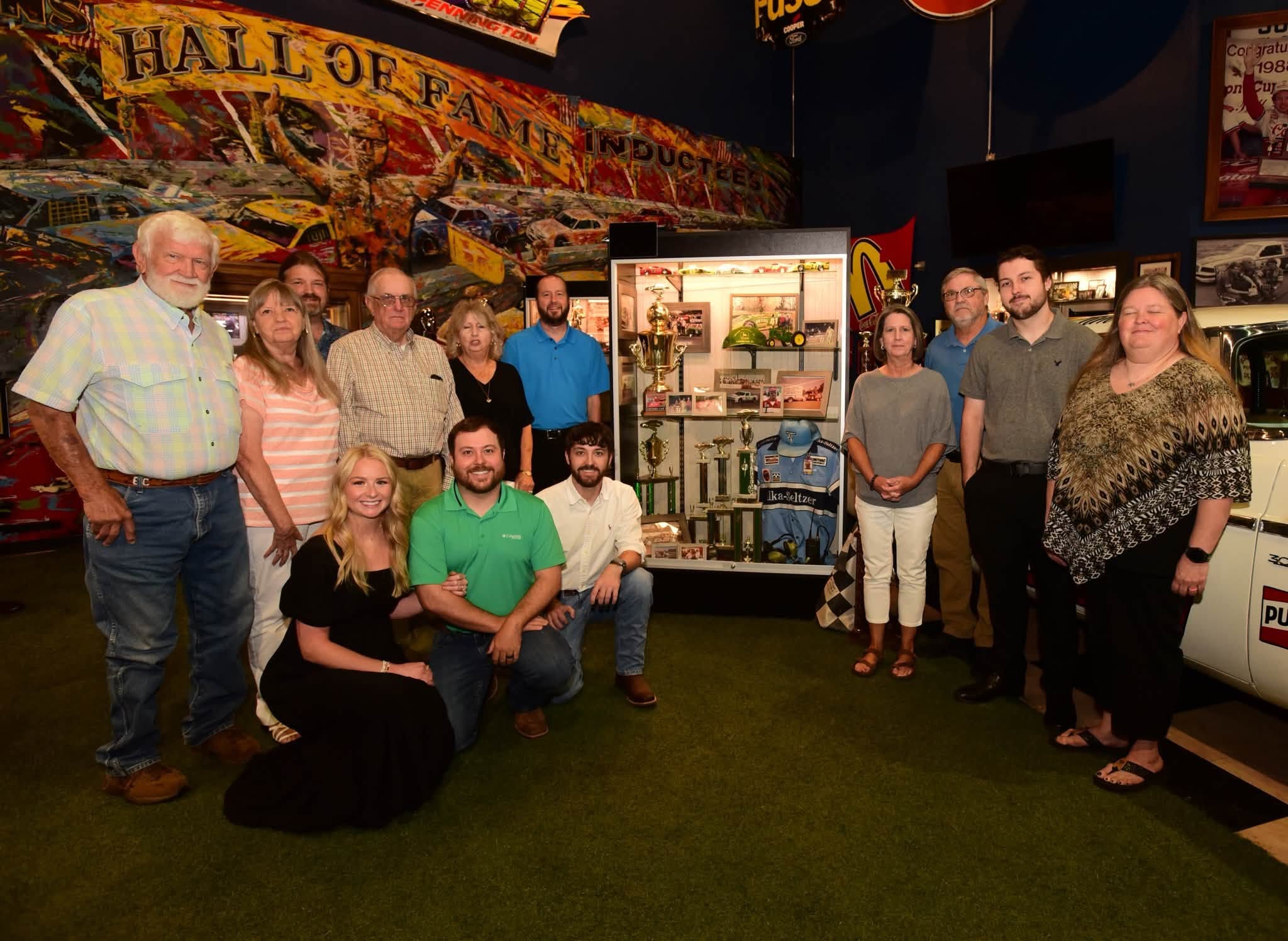 Gerald Voyles’ family and supporters gathered Saturday at his display after he was inducted to the Georgia Racing Hall of Fame at 415 Highway 53 East in Dawsonville. The museum is open Monday through Saturday from 10 a.m. until 5 p.m. and Sunday from 1-5 p.m. (Photo by Tom Reed, courtesy of the Georgia Racing Hall of Fame)