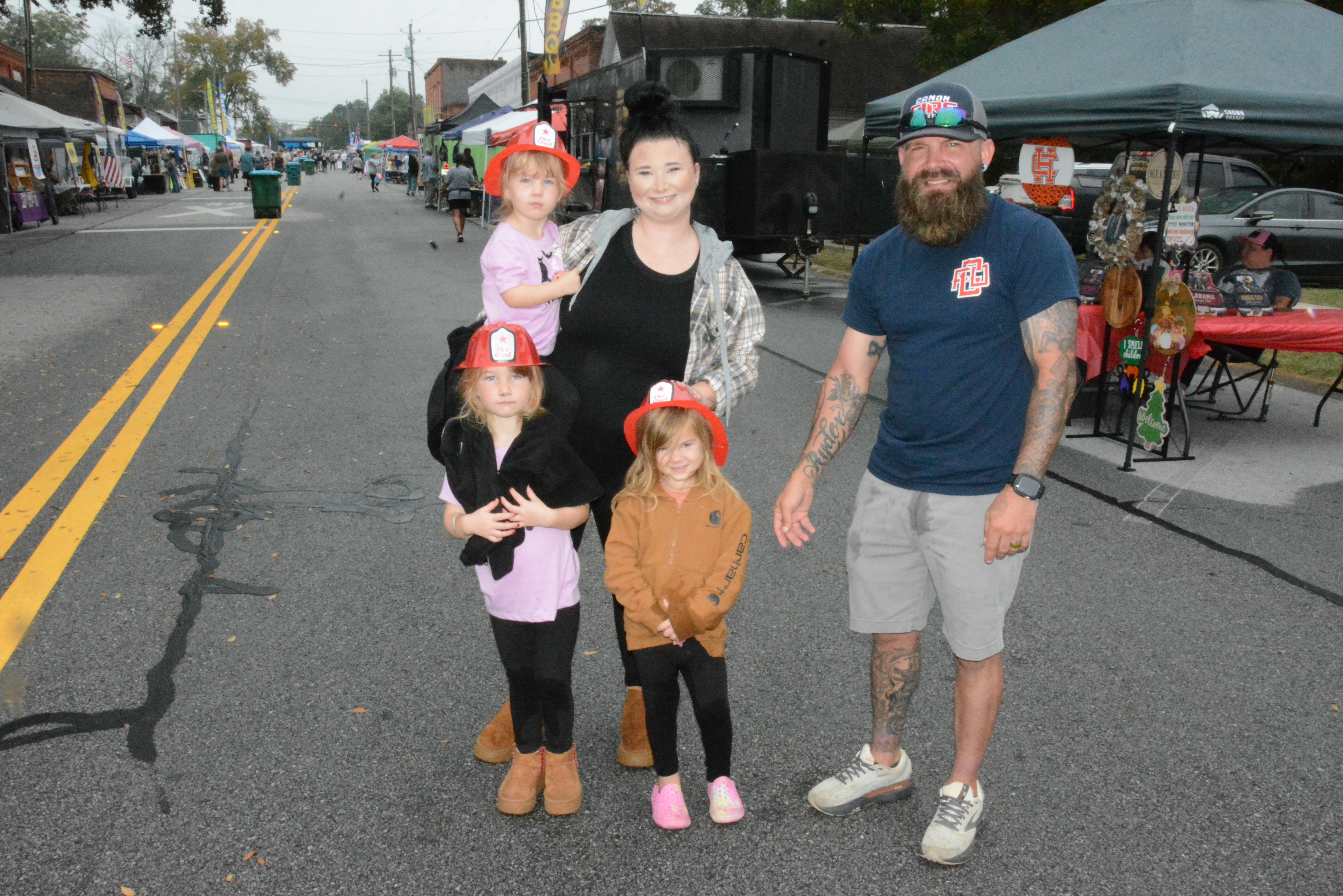 The Canon Volunteer Fire Department had one of the most popular booths at Canon’s Fall Festival on Saturday. They were giving out free kiddie fireman hats and selling chances in the rubber duck race.  Sporting their fireman hats were Blake Reynolds (in mother’s arms), Stella Reynolds (black sweater over pink shirt) and Oaklynn McClenton (brown jacket), along with Sarah Reynolds and Drew Pullian. 