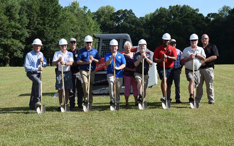 Taking part in a groundbreaking ceremony Tuesday for a new amphitheater at the Royston Wellness and Community Park are (from left) City Manager Ed Andrews,  Council Member Wayne Braswell, Street Superintendent Patrick O’Neal, Council Member Matt Fields, Mayor David Jordan, Shirley Rosenberg of the Downtown Development Authority, Council Member Kenneth Roach, Council Member Keith Turman, Water Superintendent Jammie Cawthon, Council Member Lee Strickland and Police Chief Donnie Bolemon. (Photos by Scoggins)
