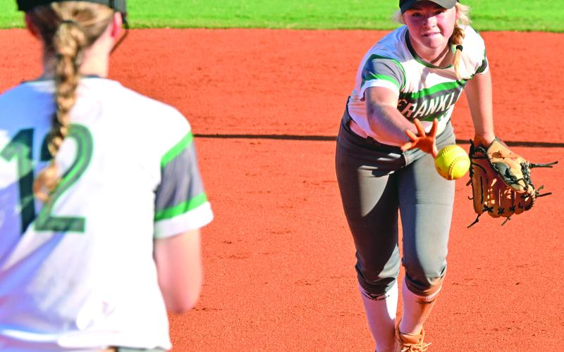 Ginger Mitchell flips a ball to Lauren Hambrick for an out at first base during the Franklin County Lady Lions’ 13-5 win over Monroe Area Thursday in Carnesville. (Photo by Scoggins)