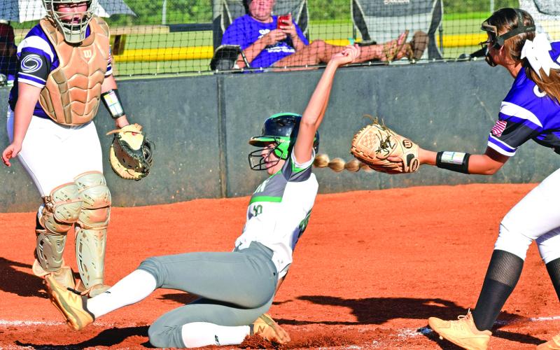 Jaden Cheek slides safely into home against Monroe Area.