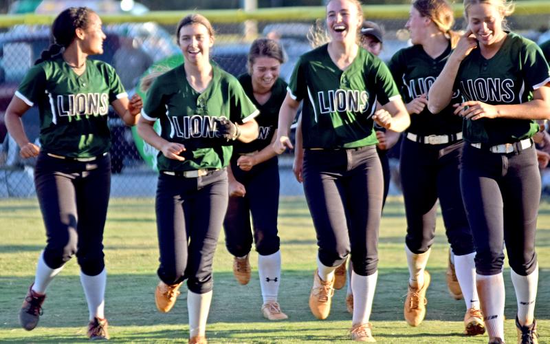 The Franklin County Lady Lions celebrate on the field Thursday after eliminating Coahulla Creek with a 14-0 win at FCHS.