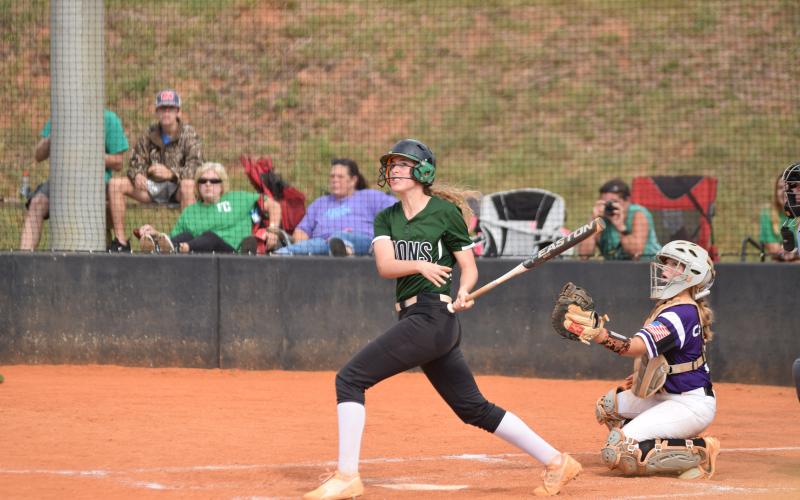 Lady Lion Lauren Hambrick watches a ball she hit during an at-bat Saturday against Monroe Area.