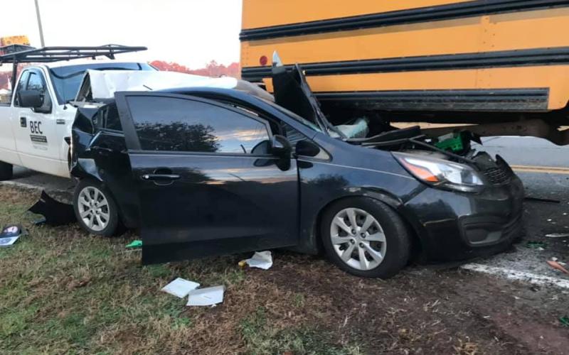 The driver of a Kia Rio was injured Thursday when his car was rear-ended and pushed into and under a school bus that was stopped to pick up a student. (Photo courtesy of Jordan Britton)