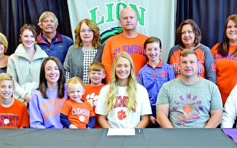 Pictured at Jaden Cheek’s scholarship signing with Clemson University last week are (front, from left) Carson Cheek, Megan Cheek, Cullen Cheek, Jaden Cheek, Jeff Cheek, Joe Cheek, (back) Joey Cheek, Sherri Cheek, Alex McLeroy, Mike Carson, Ellene Carson, Tucker Ruark, Matt Ruark, McKinlee Turner, Terri Cheek and April Ruark. Jaden is also the granddaughter of the late Raynell Cheek.
