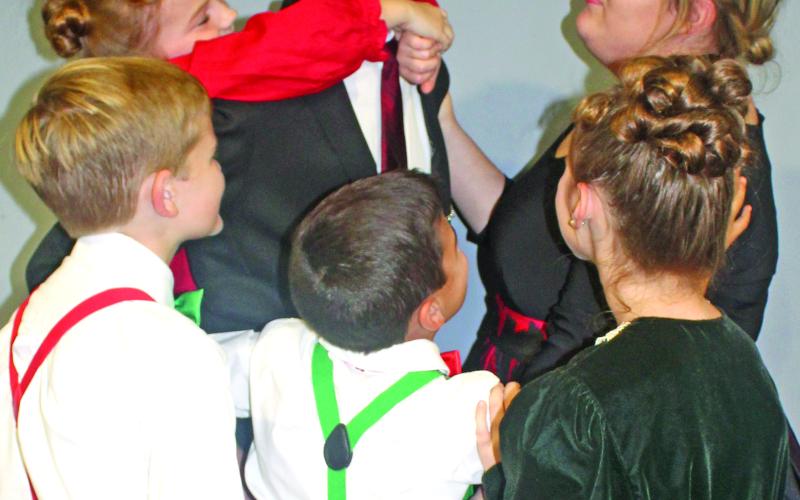 The Baileys – George (Noah Umbehant), Mary (Victoria Burns), Pete (Hunter Collins), Tommy (Brock Fowler), Janie (Mia Patterson) and Zuzu (Colbie Patterson) – embrace as a family in a scene from the beloved Christmas classic “It’s A Wonderful Life.” Franklin Community Players will bring the a play version of the beloved movie to the Lavonia Cultural Center  this weekend. Showtimes are Friday at 7 p.m., Saturday at 2:30 and 7 p.m. and Sunday at 2:30 p.m.  Tickets are $12.50, and seats are reserved.   Tickets