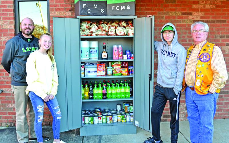 Attending the unveiling of the Franklin County Middle School Leo Club’s Take and Give Box at the Lavonia Police Department are (from left) FCMS Principal C.J. Wilder, Leo Club members Lealyn Day and Tyler Albrecht and Lavonia Lions Club member David Howell. (Photo by Eberhardt)