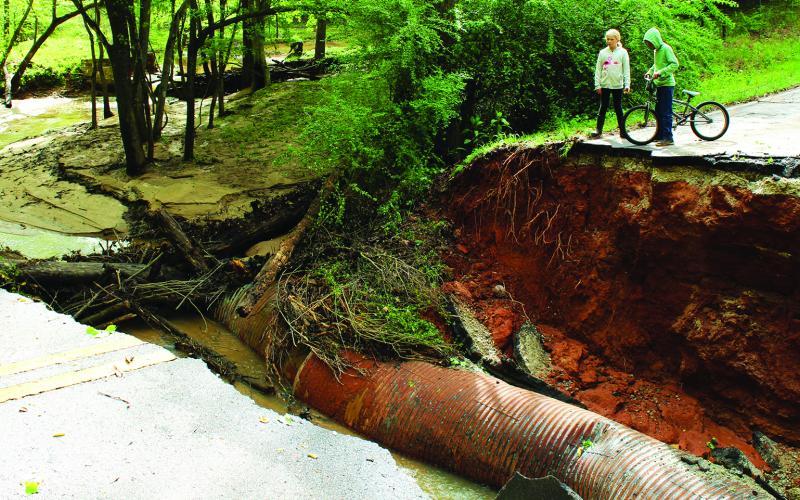 In April, up to six inches of rain fell on Franklin County, washing out roads, including Rocky Ford Road (above) and bridges. A Madison County Swift Water Rescue Squad (right) was called in to rescue a family on Goolsby Road after their yard was flooded.