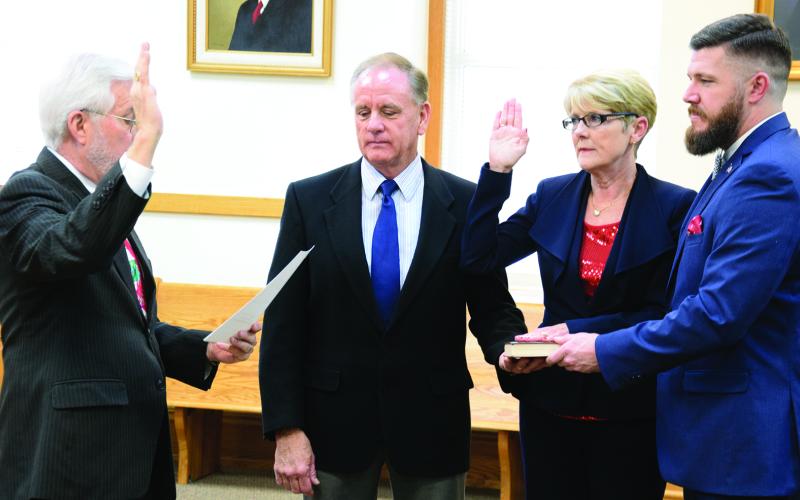 Long-time Franklin County Clerk of Court Missy Holbrook, pictured with husband Greg and son Josh Blakely during her swearing-in ceremony in 2016, has announced she will not seek reelection and will retire.