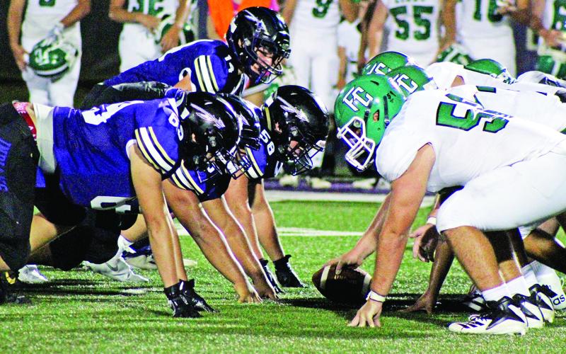 The Franklin County High School Lions football team (shown lining up this past Friday against Lumpkin County in Dahlonega) will play its first game of the season in Ed Bryant Stadium Friday against Banks County. Local officials have set forth guidelines to protect students from exposure to the coronavirus. (Photo courtesy of Jake Cantrell of The Dahlonega Nugget)