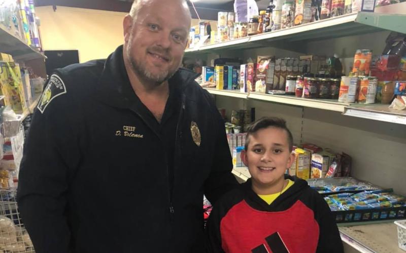 Hunter Blackmon (right), 11, a sixth grader at Franklin County Middle School, recently donated $120 to the Rainbow Pantry in Royston from money he made operating a store near Victoria Bryant State Park. The Rainbow Pantry’s Donnie Bolemon accepted the donation.
