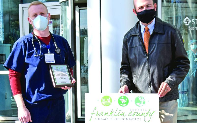 Dr. Clay Hearn (left in right photo) was named the Franklin County Chamber of Commerce’s Citizen of the Year last week, and Chick-Fil-A in Lavonia (above) was named Business of the Year. Chamber officers surprised Hearn and Chick-Fil-A Operator Will Lowe (above, center) with the awards. The chamber’s regular banquet where the awards are traditionally presented had to be cancelled this year due to the coronavirus pandemic.