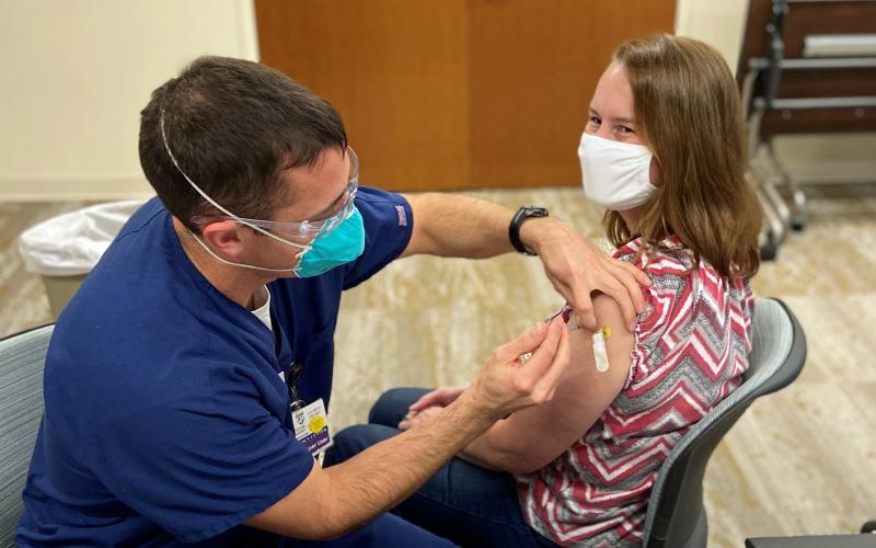 St. Mary's Sacred Heart Hospital Emergency Department nurse practitioner Ruth Tellano Daniel receives one of the first doses of vaccine from Emergency Department Manager Tyler Davison. (Photo courtesy of St. Mary’s Sacred Heart Hospital)