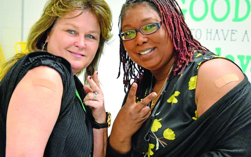 Lavonia Elementary School teachers Deborah Crewe and Sumeko Raines proudly show off they got vaccinated Friday morning. (Photo by Sinclair)