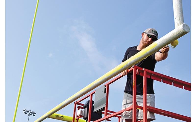 New Franklin County Lion Head Coach Parker Martin worked Sunday to paint the goal posts at Ed Bryant Stadium. (Photo by Scoggins)